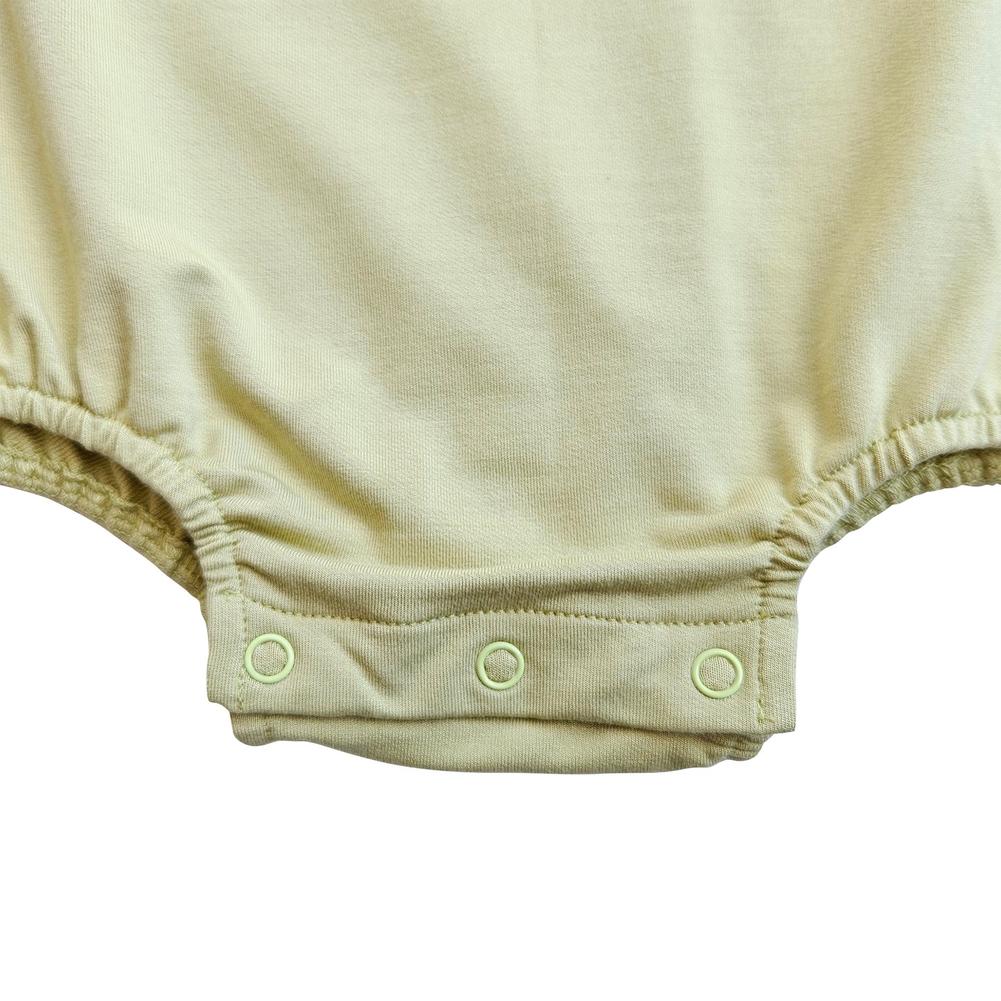 Issy & Lilo oversized baby bodysuit in a soft green color, featuring snap closures at the bottom for easy diaper changes, made from breathable bamboo for ultimate comfort.