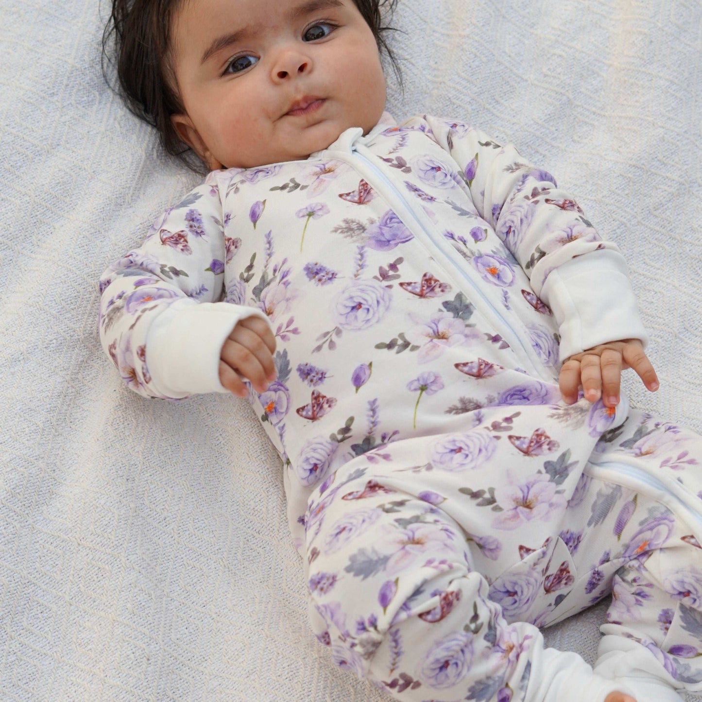 baby wearing a floral print bamboo zipper romper