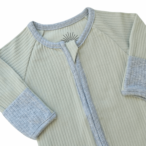 Smart organic cotton zipper romper in sage green with contrasting sky blue cuffs and zipper detail, providing a soft, breathable, and easy-to-wear design for babies.