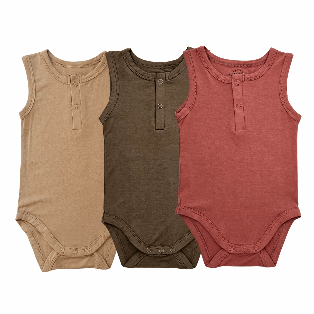 set of three sleeveless bamboo baby bodysuits in mustard, olive green, and dusty red with front button details