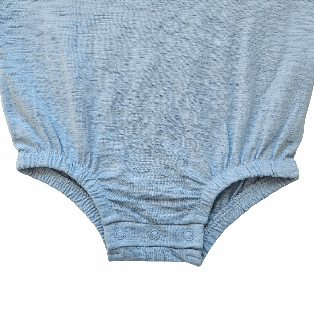 Close-up of Issy & Lilo light blue organic cotton baby bodysuit, showing elastic leg openings and snap button closure