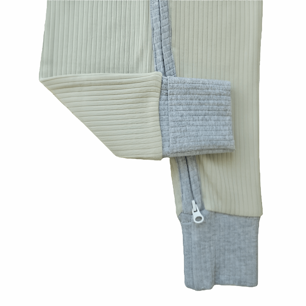 Close-up of a smart organic cotton zipper romper in sage green, showcasing the leg cuff with sky blue contrast and zipper for easy diaper changes.