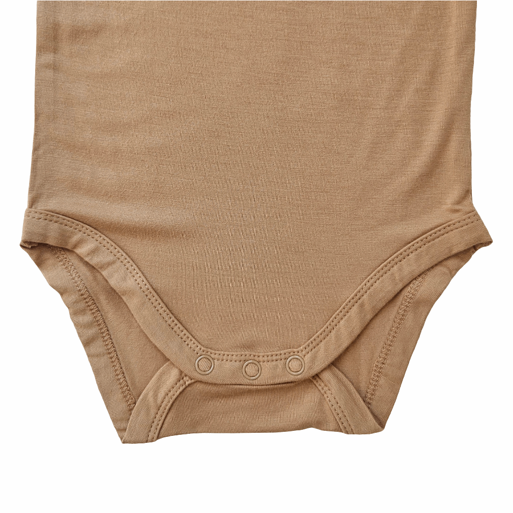 close-up of the bottom part of a mustard bamboo baby bodysuit with snap buttons